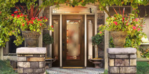 A stunning front door adorned with vibrant flowers and lush plants, creating a picturesque entrance.